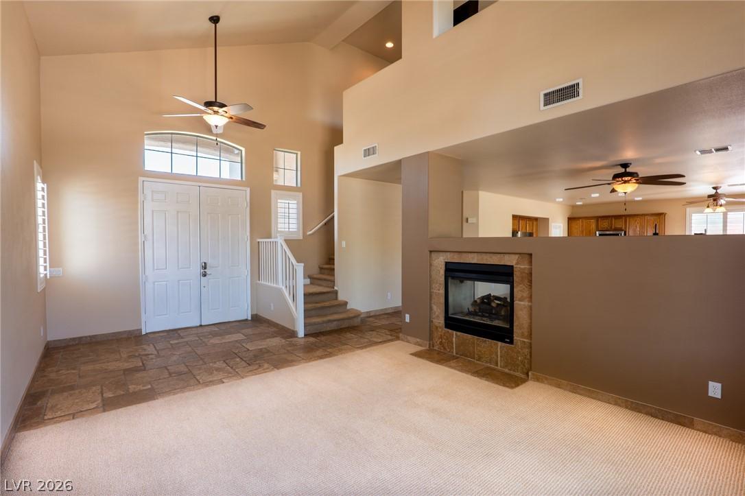 Image 4: Dramatic vaulted ceilings, a tiled fireplace, and