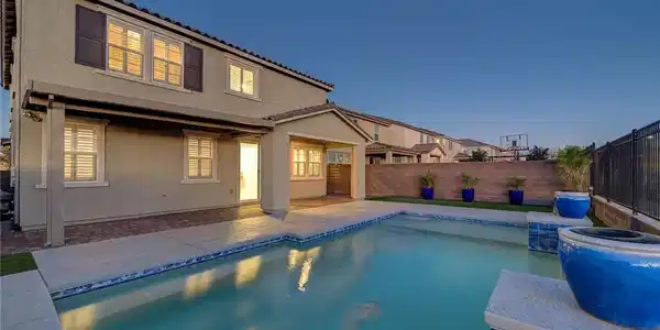 Image 3: An inviting swimming pool complements the rear ele