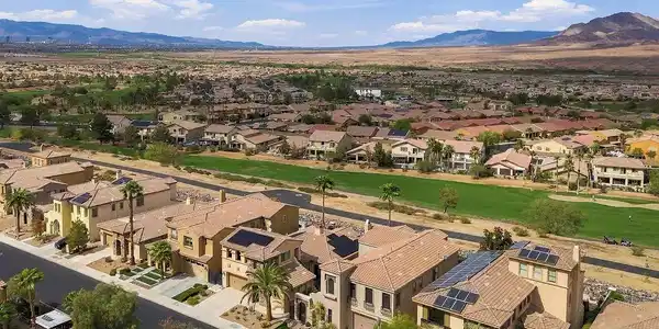 Image 4: Distant mountains frame a sprawling golf course ne