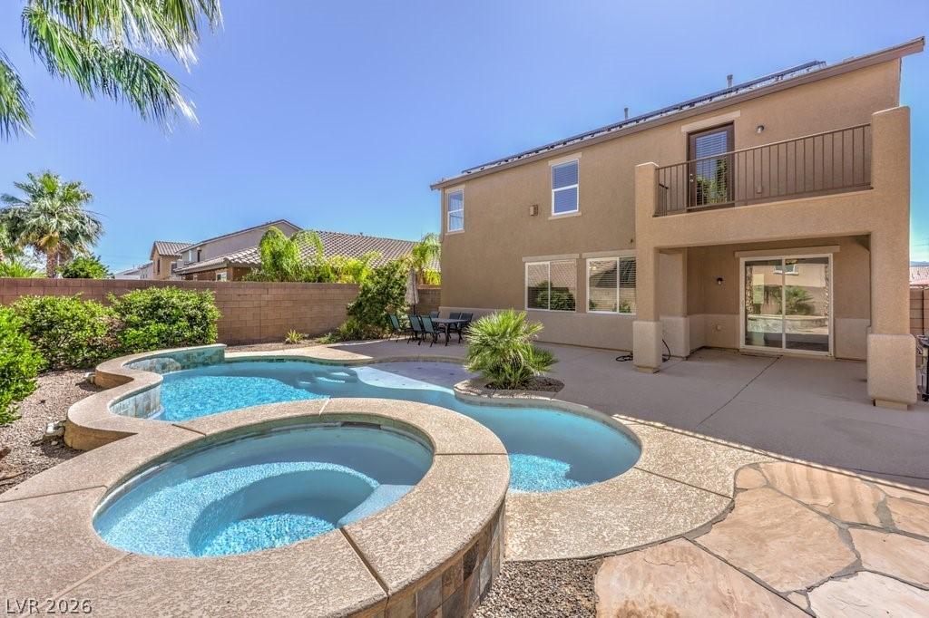 Image 2: This amazing backyard features a pool, spa, covere
