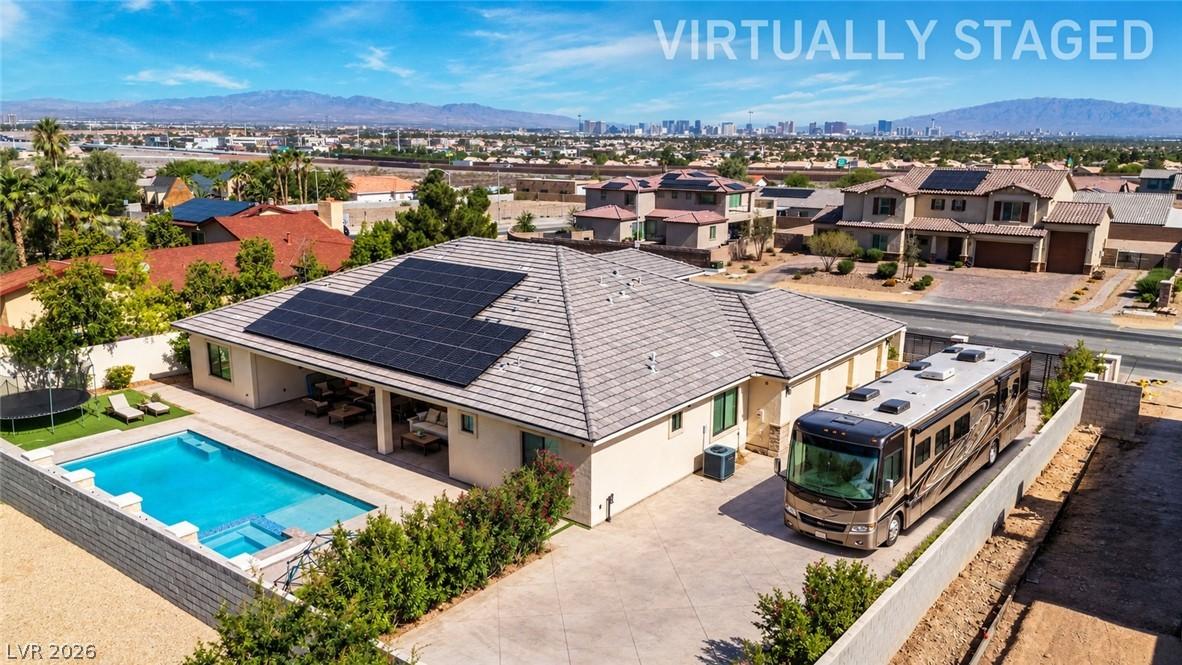 Image 3: Solar panels crown this single-story residence, co
