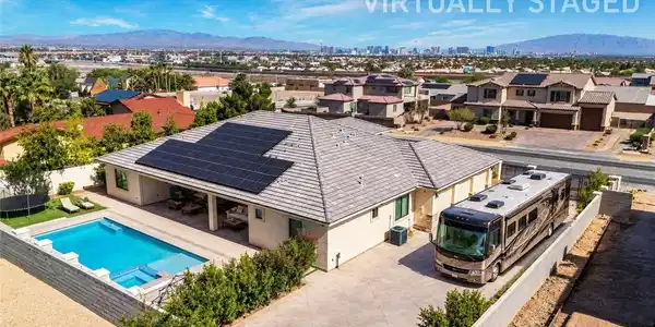 Image 3: Solar panels crown this single-story residence, co