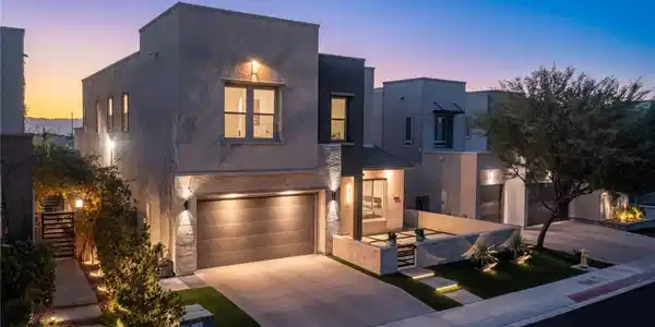 Image 2: A modern facade with illuminated pathways welcomes