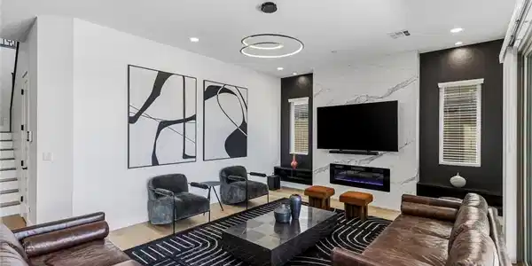 Image 3: A striking living area features a modern fireplace