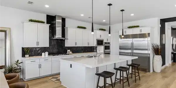 Image 4: A well-appointed kitchen features a spacious islan