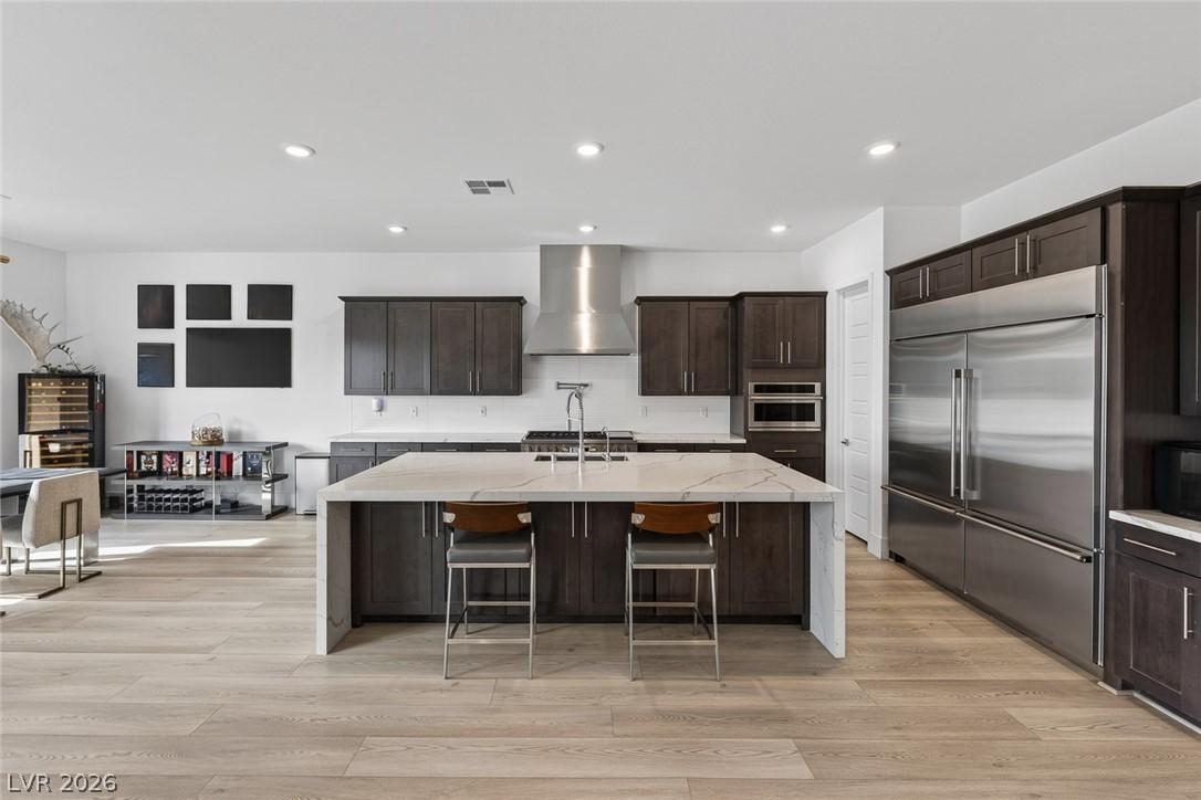 Image 3: A pristine kitchen features modern cabinetry, a ge