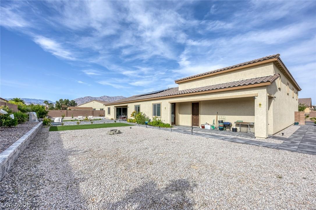 Image 4: A spacious backyard with desert landscaping and a