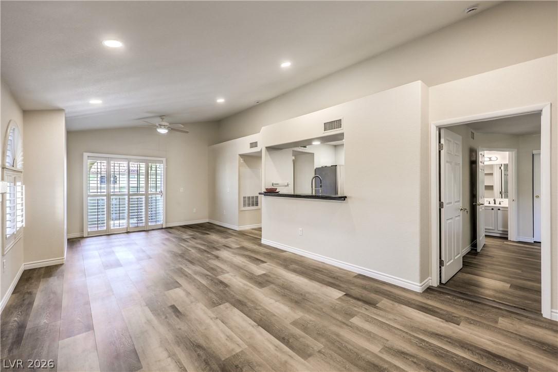 Image 2: A luminous living area showcases vaulted ceilings,