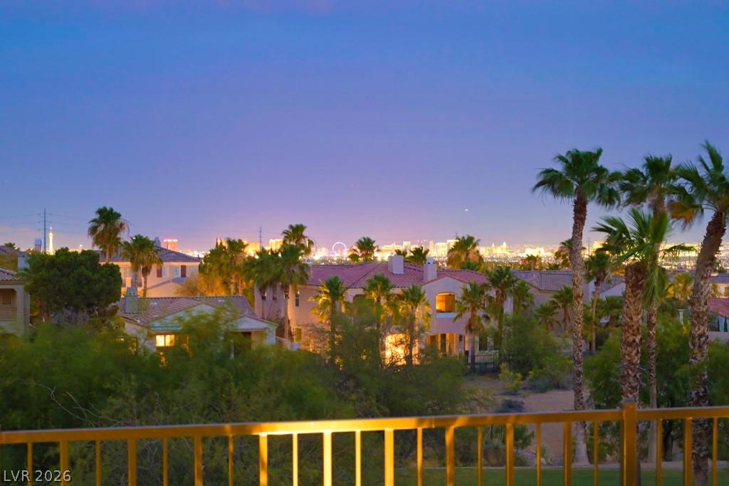 Image 3: City lights sparkle against the twilight sky, offe