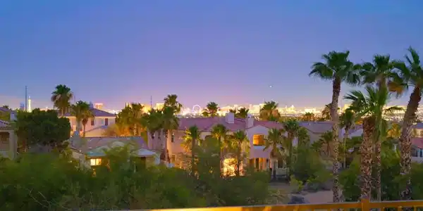 Image 3: City lights sparkle against the twilight sky, offe