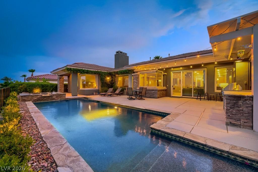 Image 4: An inviting backyard oasis offers a sparkling Pool
