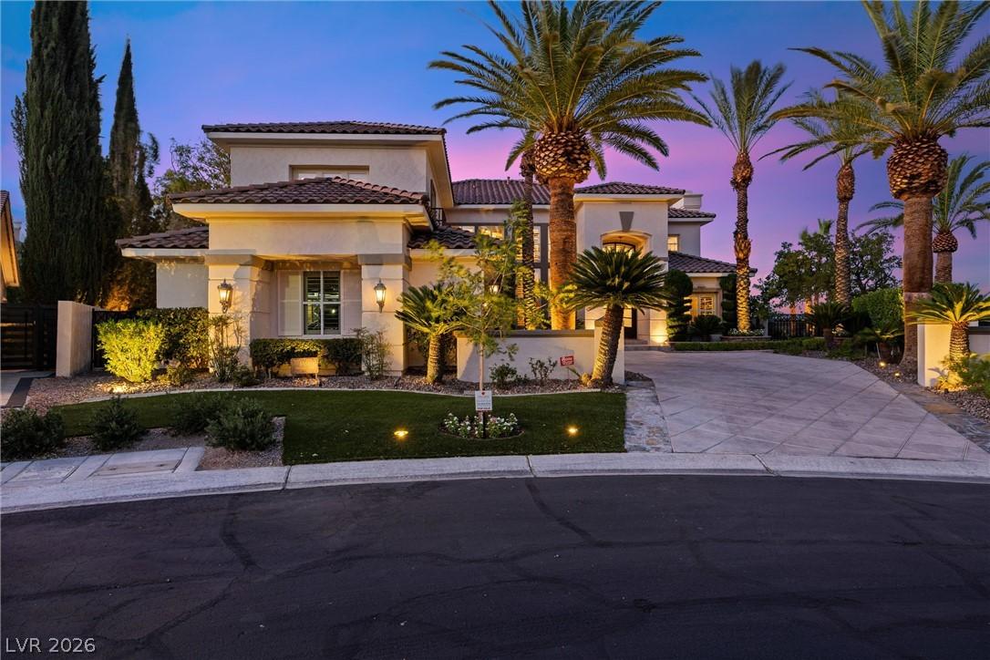 Image 4: Illuminated by dusk, this Mediterranean-inspired h