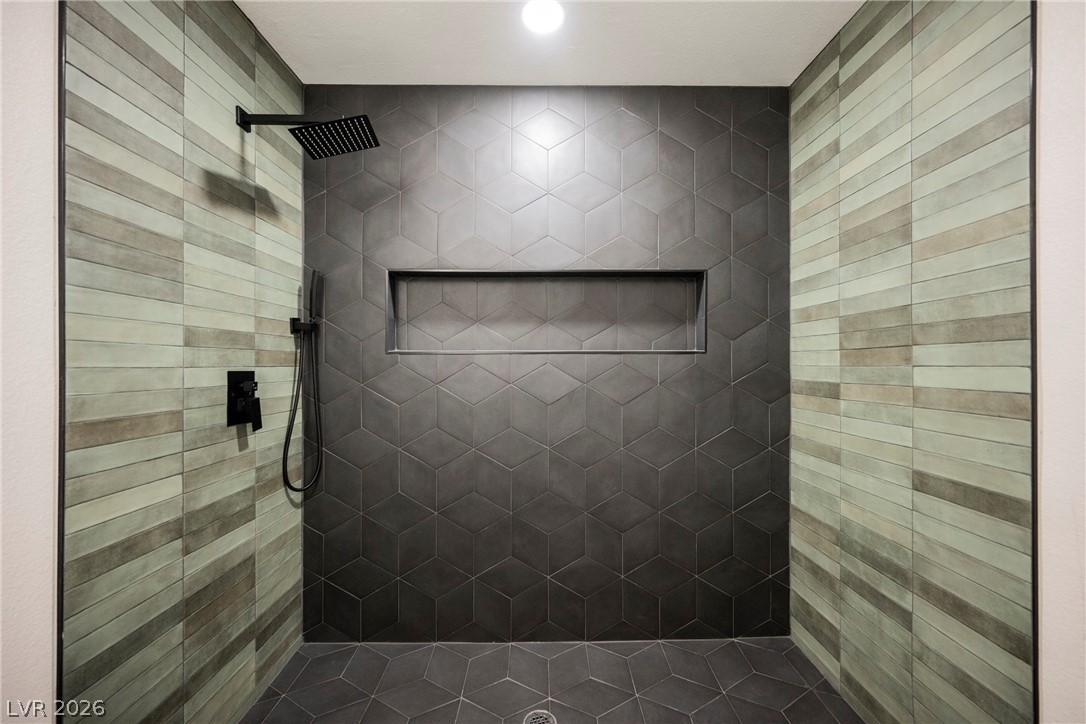 Image 2: A striking walk-in shower boasts geometric and lin