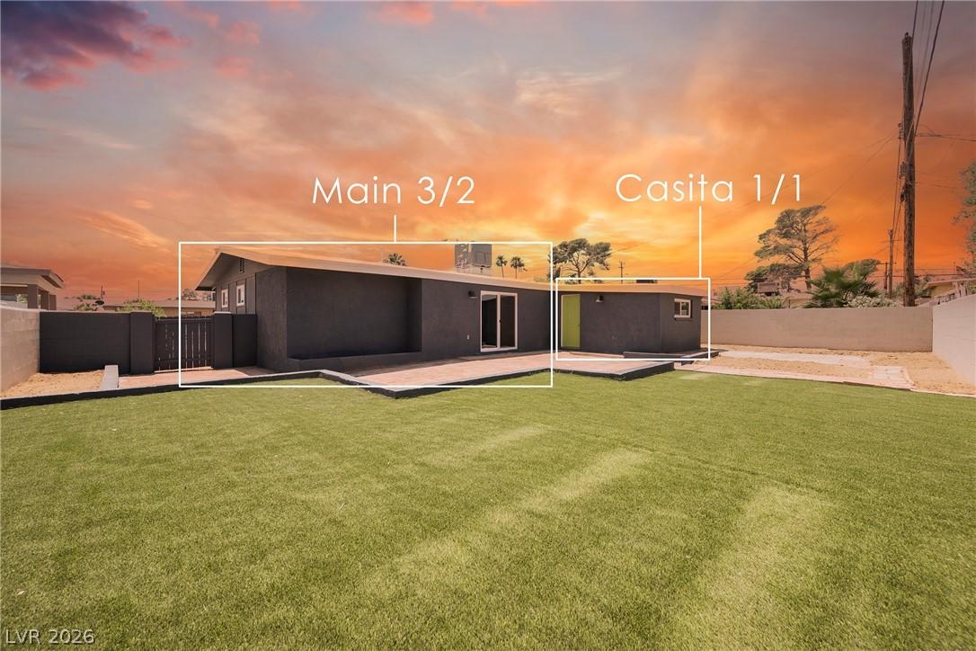 Image 4: A deep green lawn and sleek, modern architecture d
