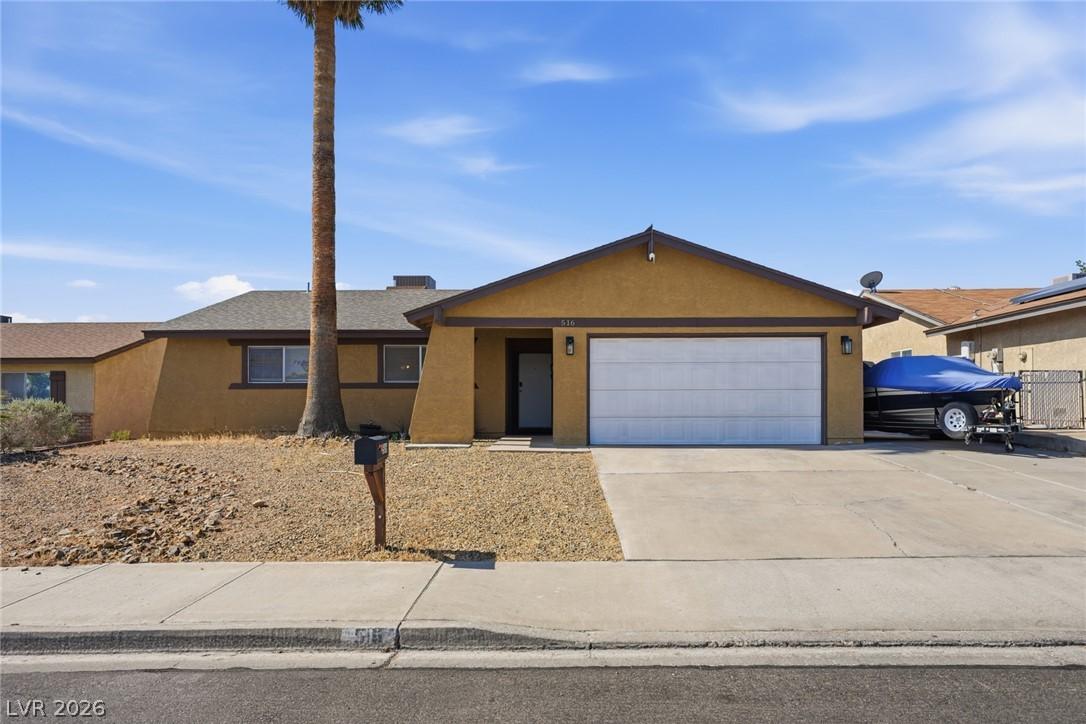 Image 2: A desert-friendly front yard and attached garage e
