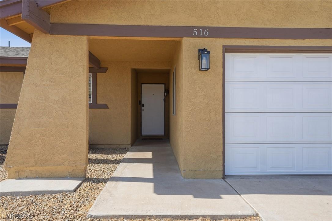 Image 4: A welcoming stucco facade features an integrated g