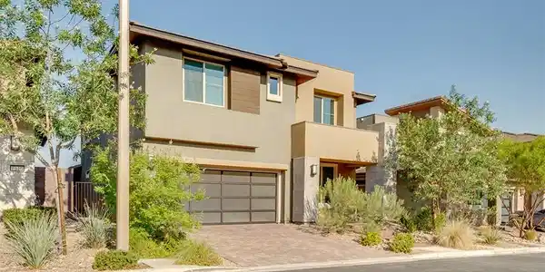 Image 2: Modern desert architecture with a paver driveway,