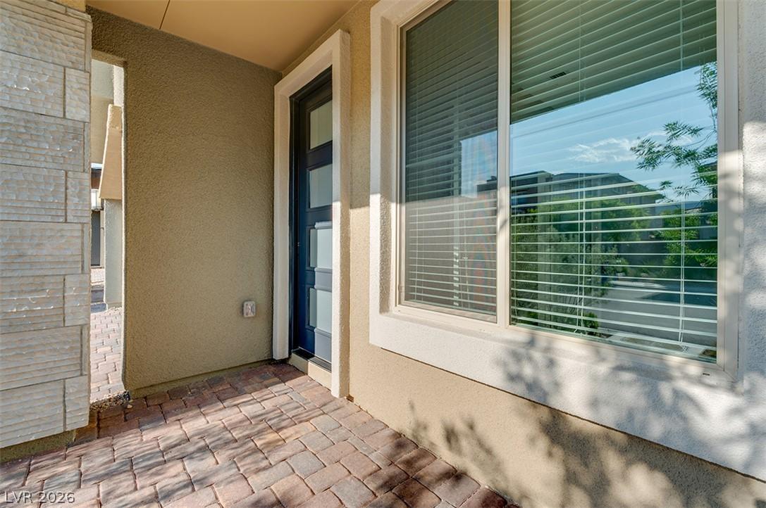 Image 3: A welcoming entry features a modern front door and