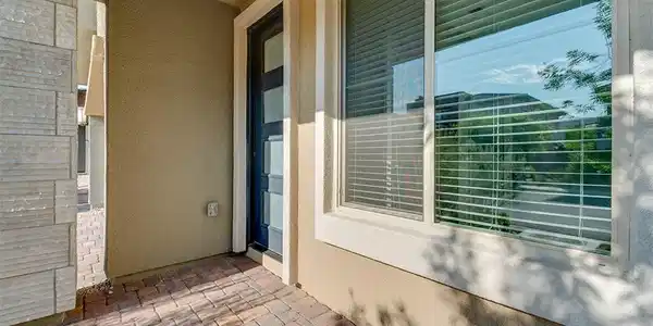 Image 3: A welcoming entry features a modern front door and