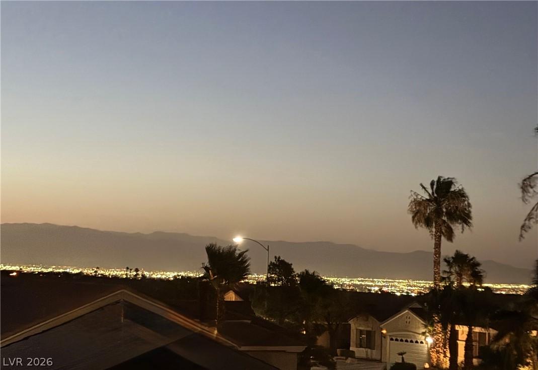 Image 2: Dramatic sunset views over the illuminated citysca