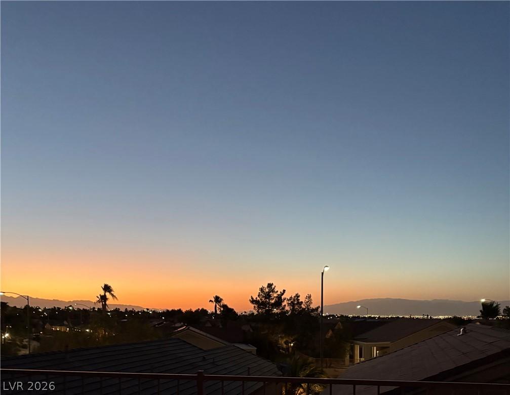 Image 3: Golden hour casts a dramatic glow over the neighbo
