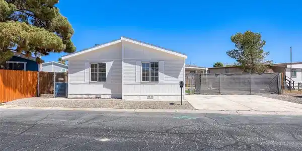 Image 2: Crisp vertical siding accents the exterior of this