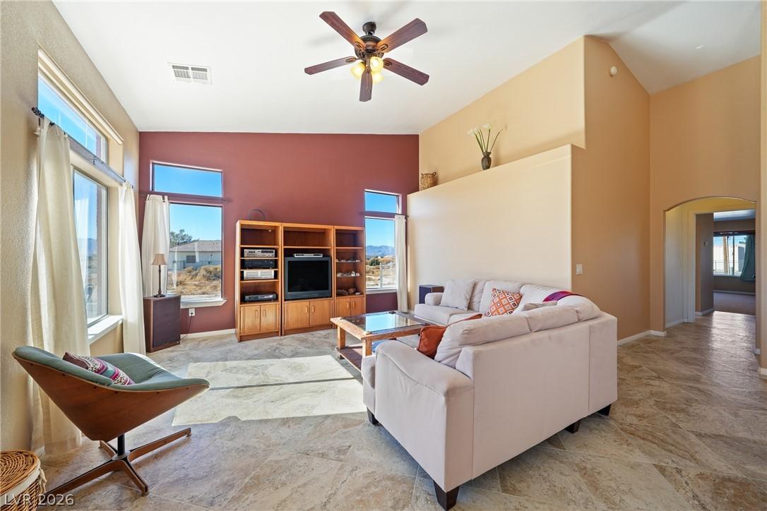 Image 4: This bright living space features tall ceilings an