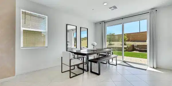 Image 2: This spacious dining area features sleek tile floo