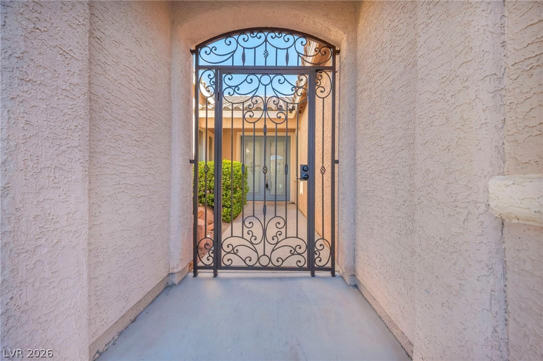 Image 4: An inviting wrought iron gate leads to a private,