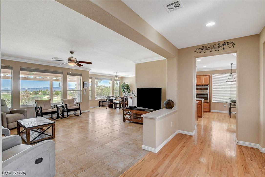 Image 4: An open concept living area boasts elegant tiled f