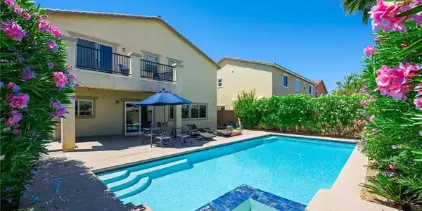Image 3: A private backyard oasis features a shimmering in-
