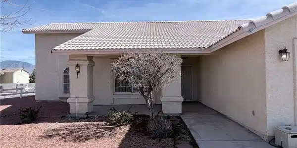 Image 3: View of exterior entry with stucco siding, a tiled