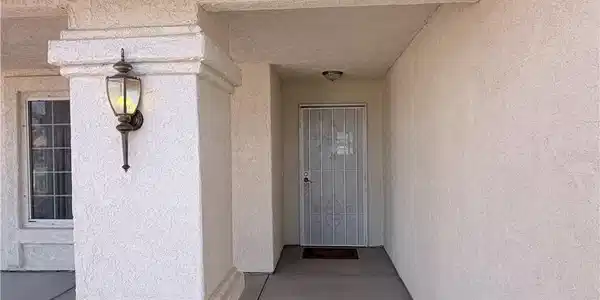 Image 4: Doorway to property featuring stucco siding