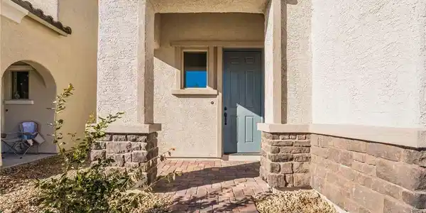 Image 3: A welcoming brick paver walkway leads to the invit