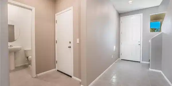 Image 4: A well-lit entry hall with tiled flooring and conv