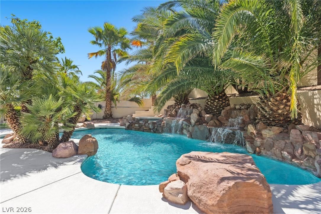Image 1: An oasis awaits with a custom pool, cascading wate