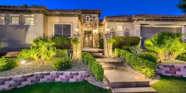 Image 2: Manicured pathways and lush desert plantings guide