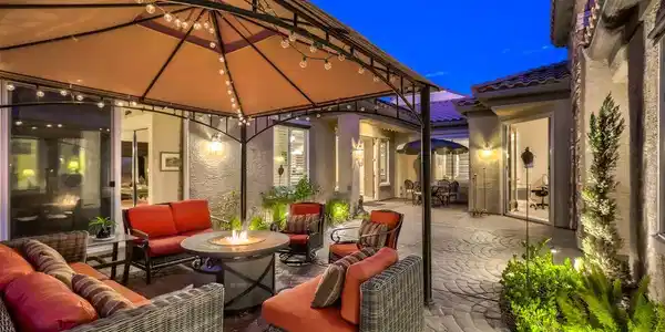 Image 4: A spacious courtyard features concrete pavers, sto