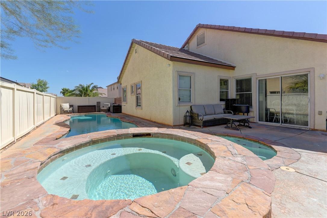 Image 2: A private backyard oasis features a shimmering poo