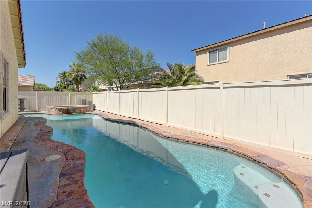 Image 3: An inviting backyard oasis awaits with a sparkling