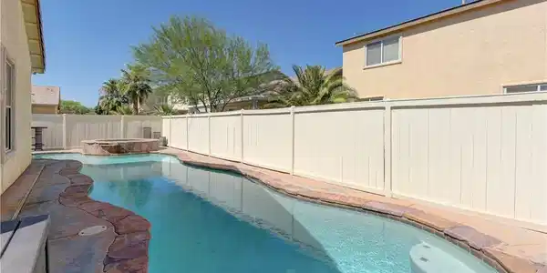 Image 3: An inviting backyard oasis awaits with a sparkling