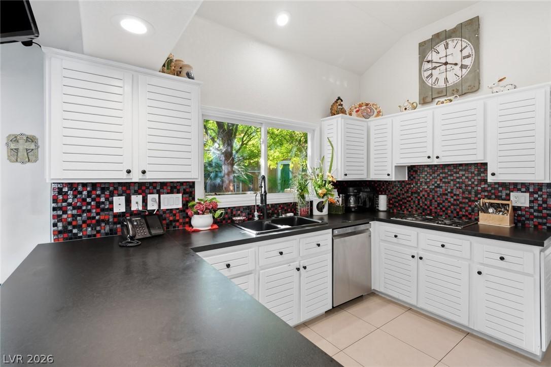 Image 3: A well-appointed kitchen features ample white cabi