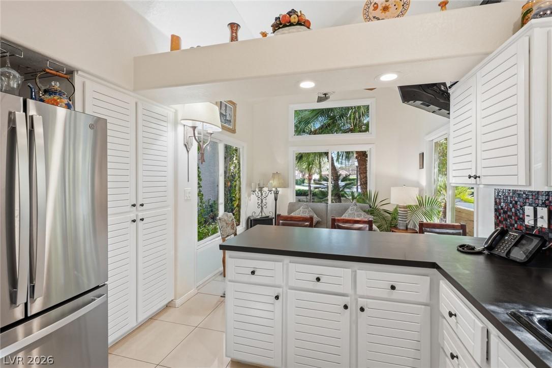 Image 4: This kitchen showcases ample white cabinetry, slee