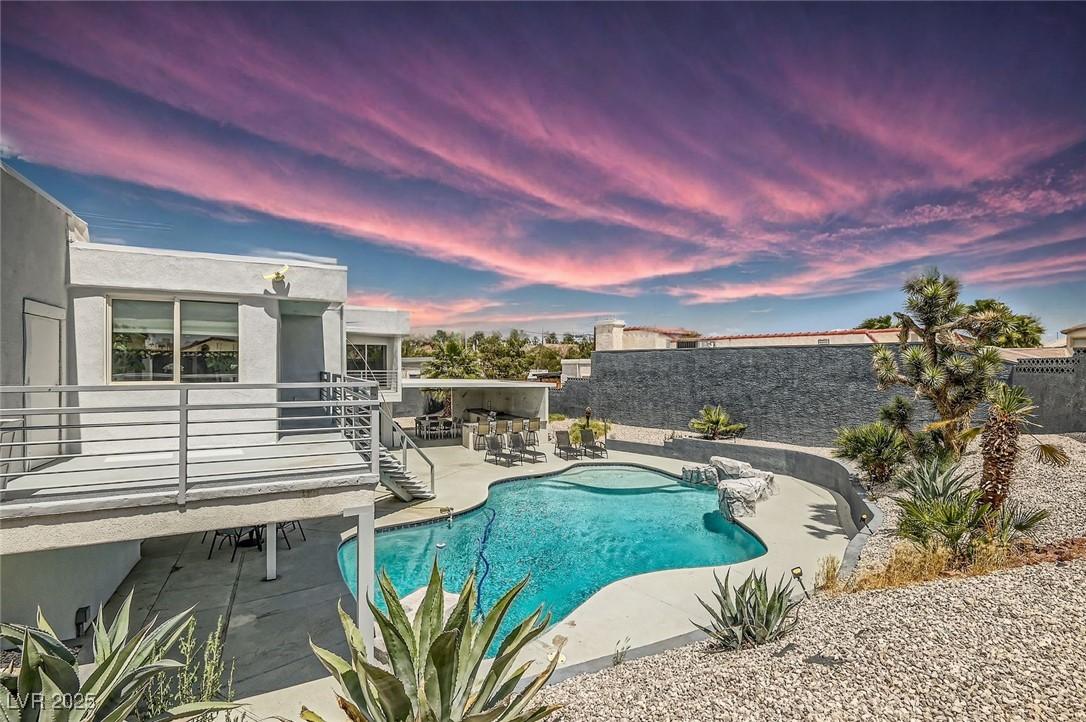 Image 3: View of swimming pool with a patio area and a fenc