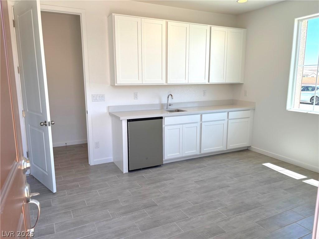Image 3: Kitchen with white cabinets, stainless steel dishw