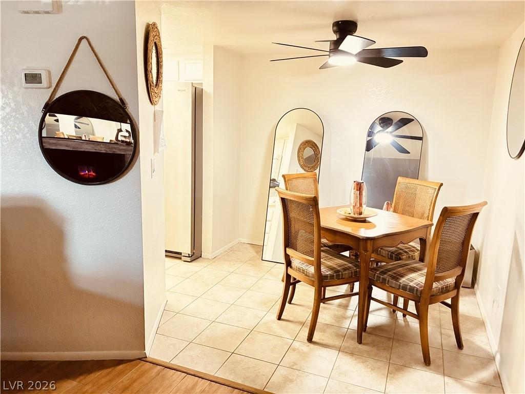 Image 2: A cozy dining area features a stylish ceiling fan,