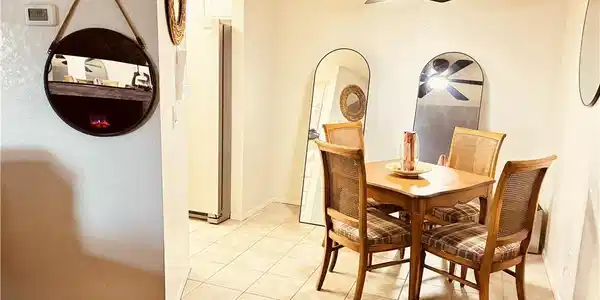 Image 2: A cozy dining area features a stylish ceiling fan,
