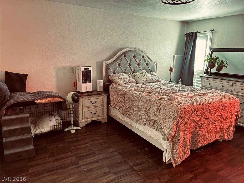 Image 4: Rich hardwood-style flooring extends across this s
