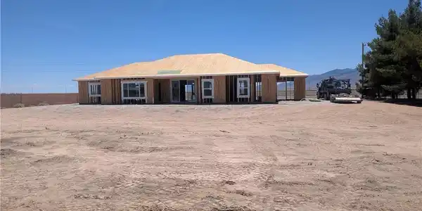 Image 3: A newly framed single-story home awaits its finish