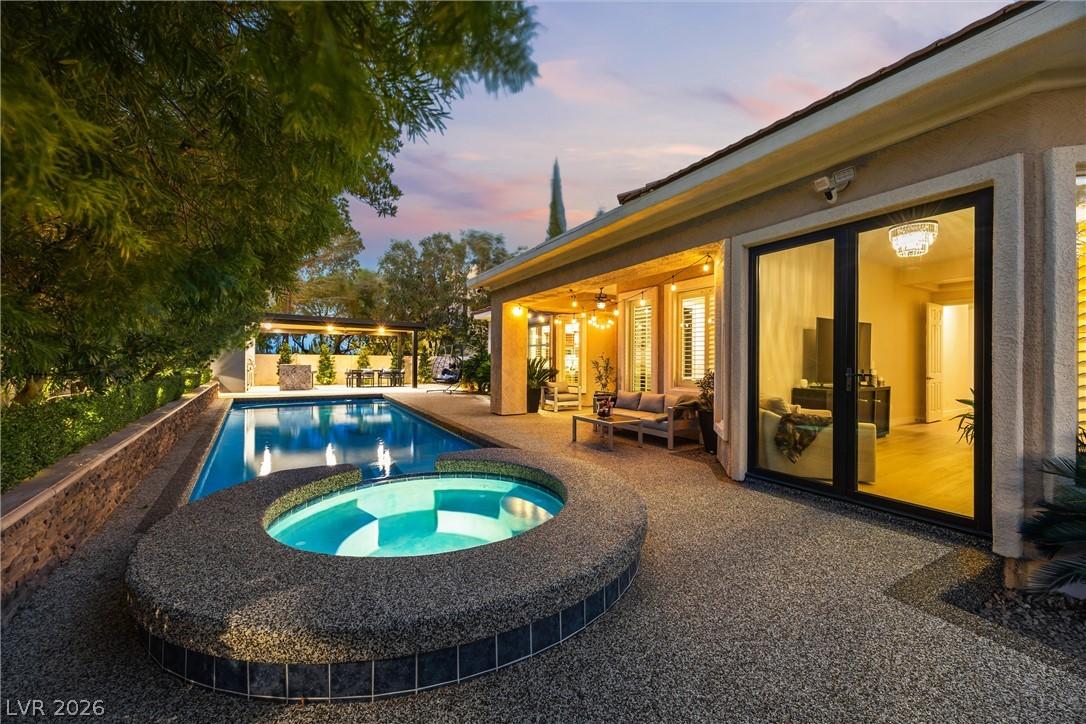 Image 1: An inviting backyard oasis offers a sparkling pool